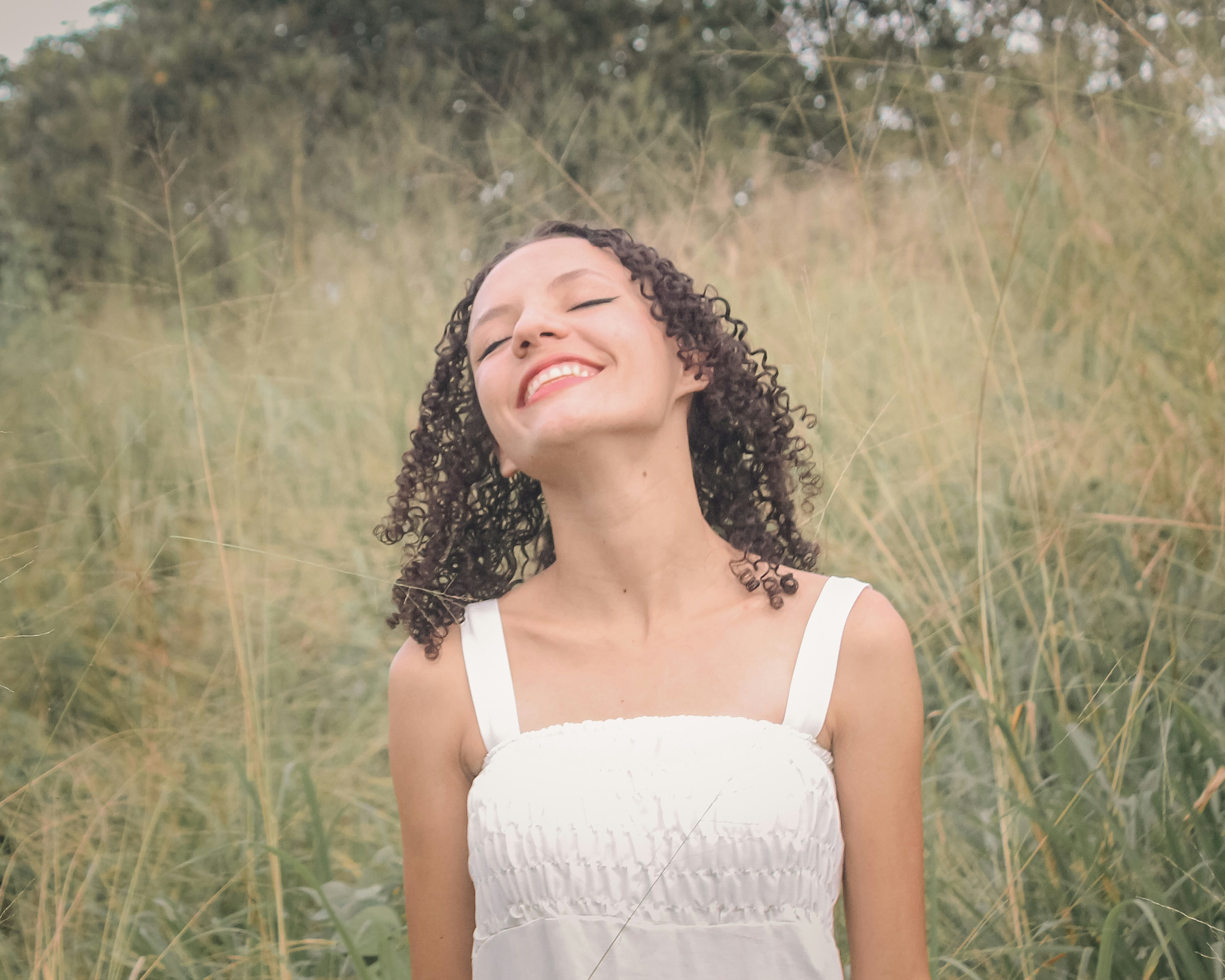 Woman breathing slowly outdoors, easing anxiety