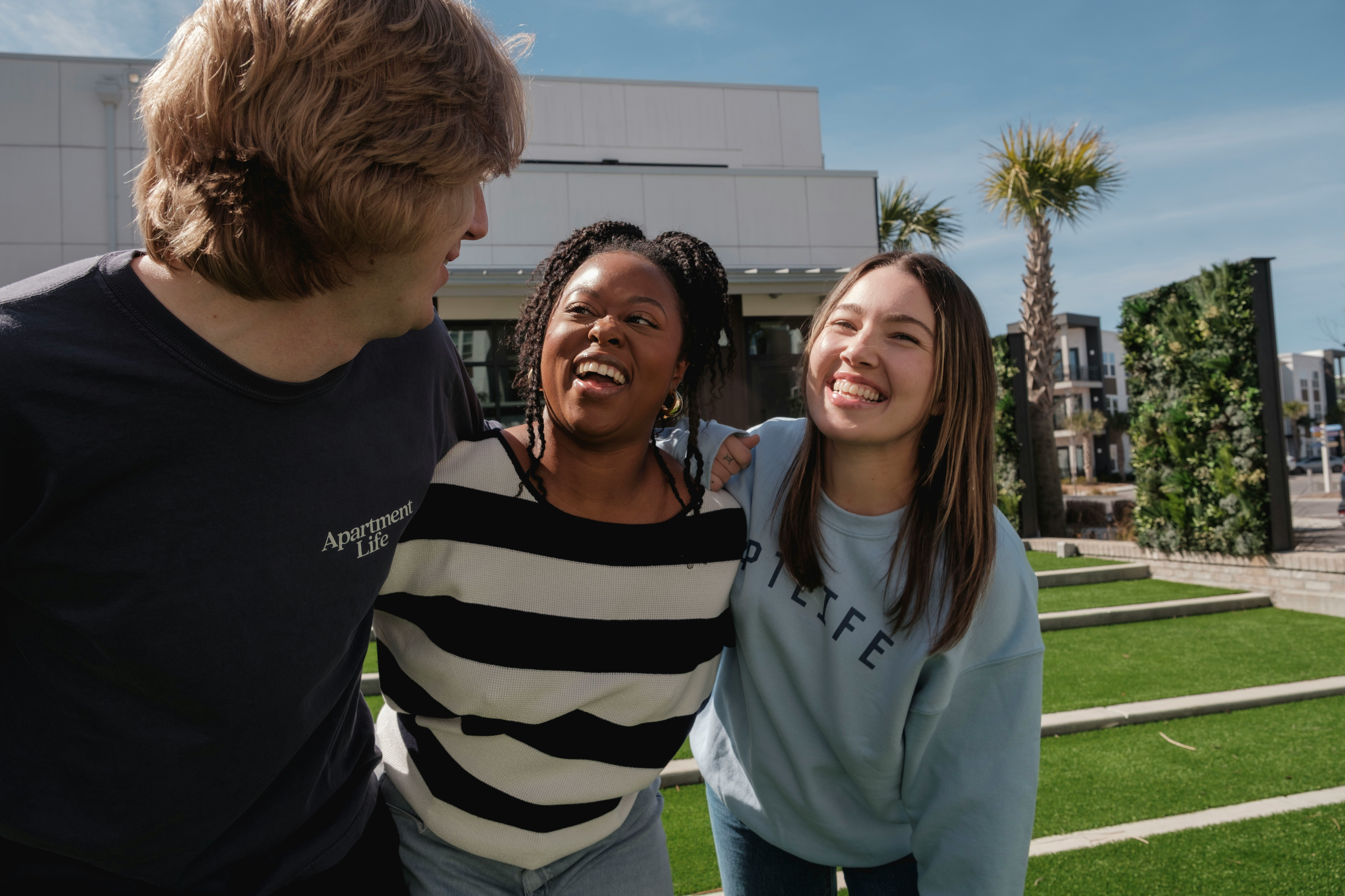 Three people connecting warmly